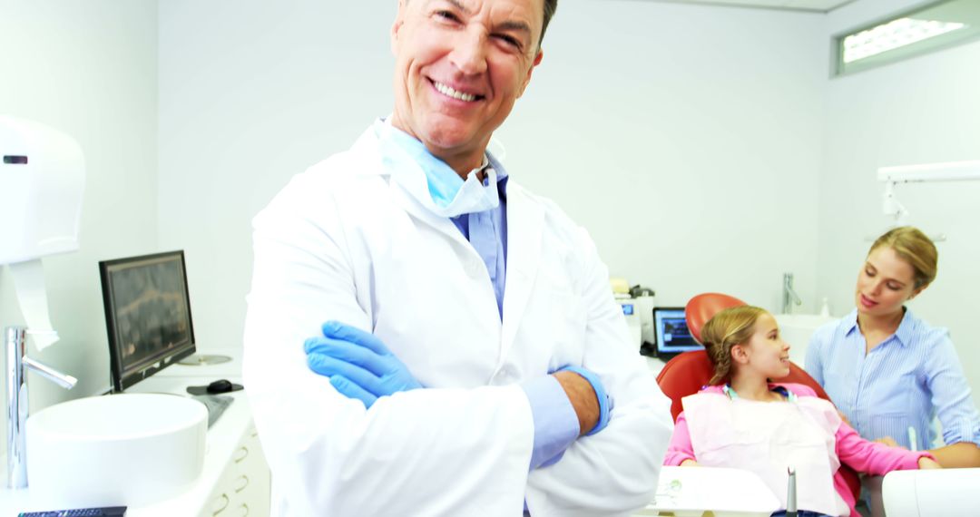 Smiling Dentist in Clinic with Young Patient and Assistant - Free Images, Stock Photos and Pictures on Pikwizard.com