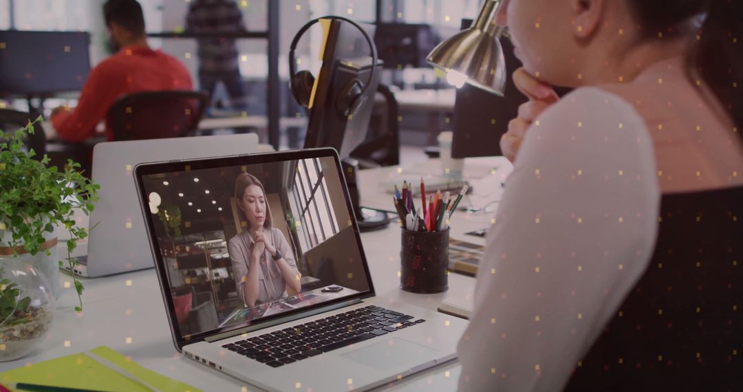 Office Worker Participating in Virtual Meeting at Modern Workspace
