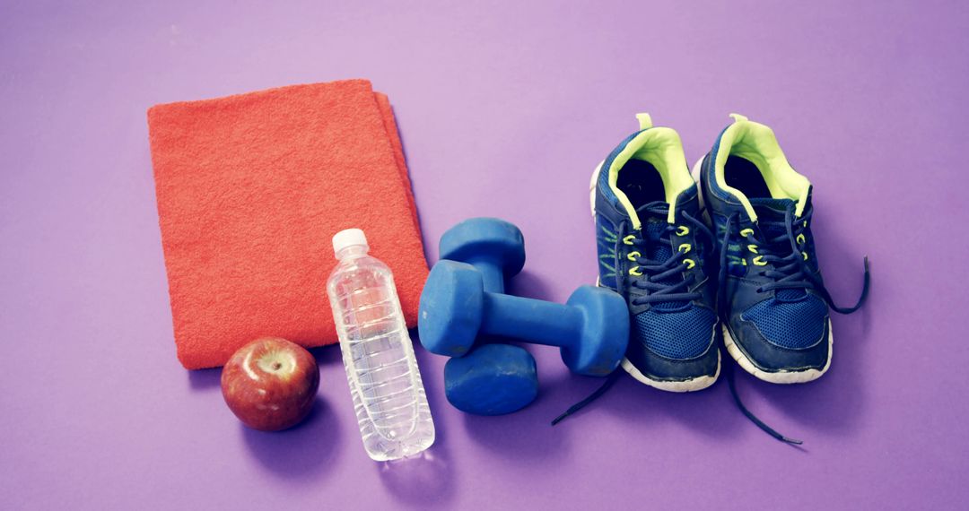 Workout Essentials Including Dumbbells, Water, and Sneakers on Purple Background - Free Images, Stock Photos and Pictures on Pikwizard.com