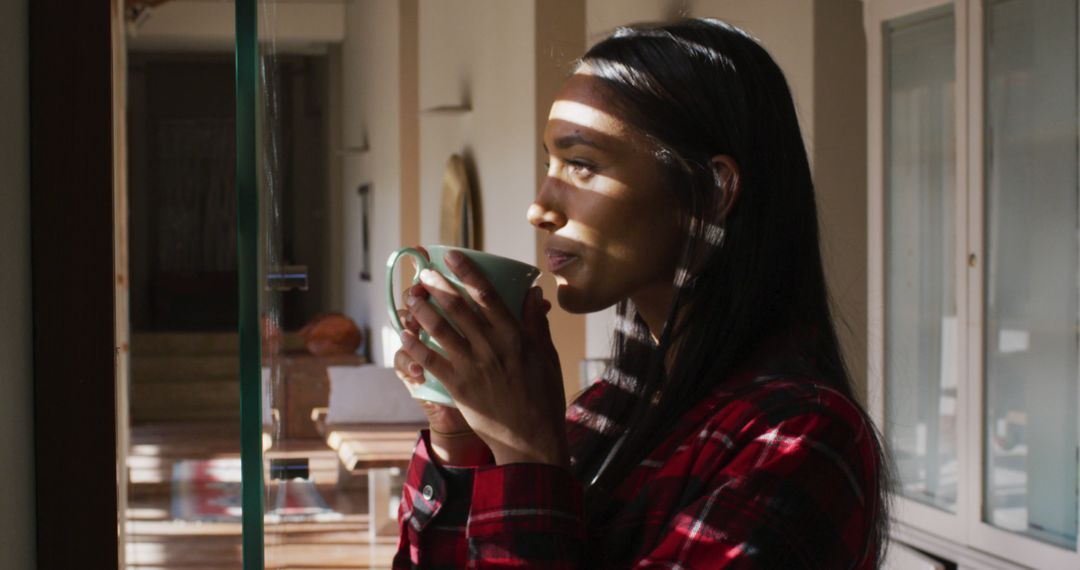 Woman Enjoying Morning Coffee by Window in Sunlit Room - Free Images, Stock Photos and Pictures on Pikwizard.com