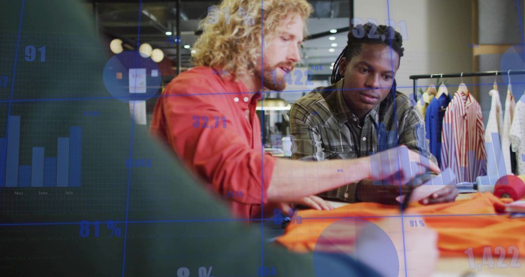 Retail team analyzing sales data and fabric using tablet in modern clothing store