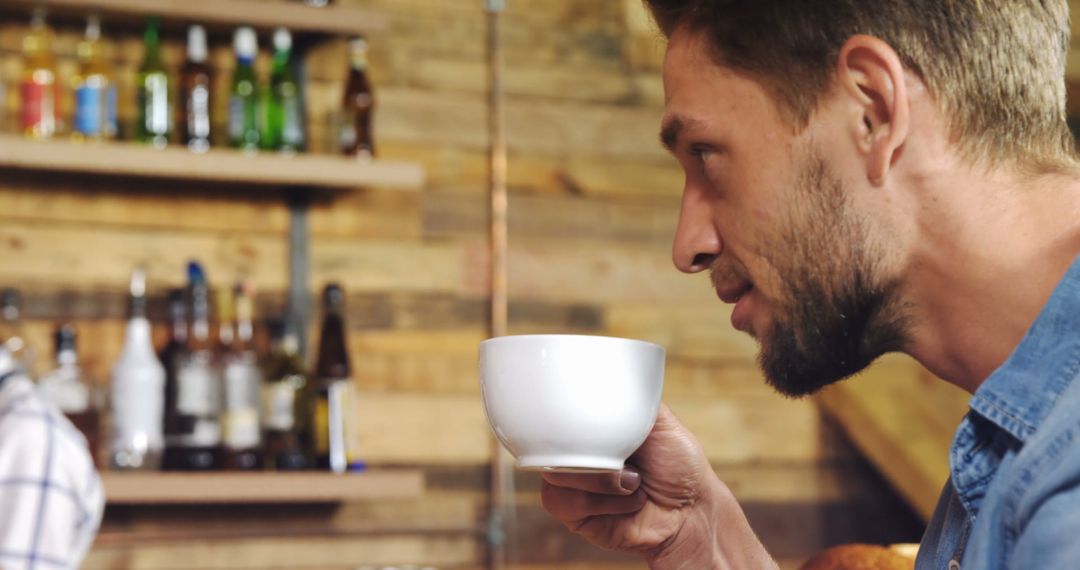 Young Man Relaxing with Cozy Coffee in Rustic Cafe