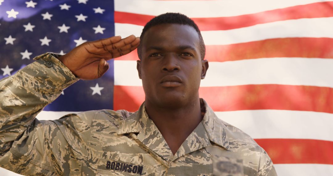 Proud African American Soldier Saluting Before US Flag - Free Images, Stock Photos and Pictures on Pikwizard.com