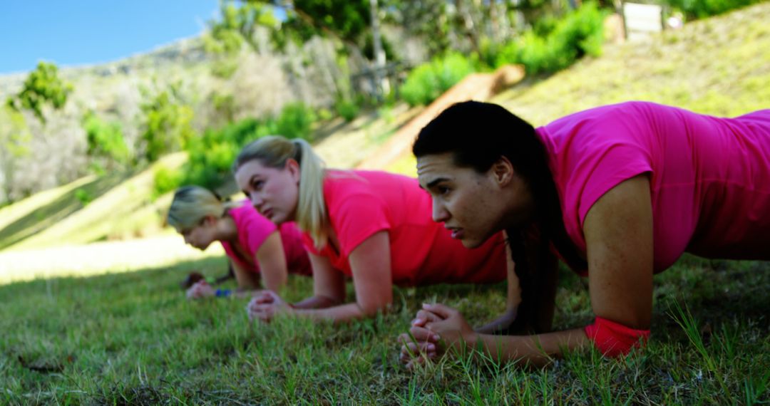 Women Exercising Outdoors with Plank Pose in Pink Shirts - Free Images, Stock Photos and Pictures on Pikwizard.com