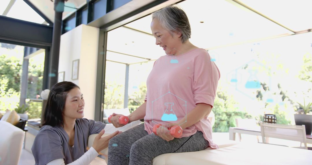 Senior woman lifting pink dumbbells on bench while caregiver guiding home exercise routine