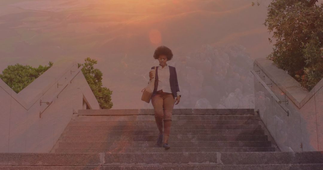 Professional Woman Walking Down Steps with Briefcase While Using smartphone