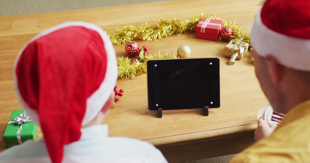 Family Enjoying Tablet Together at Christmas Celebration - Free Images, Stock Photos and Pictures on Pikwizard.com