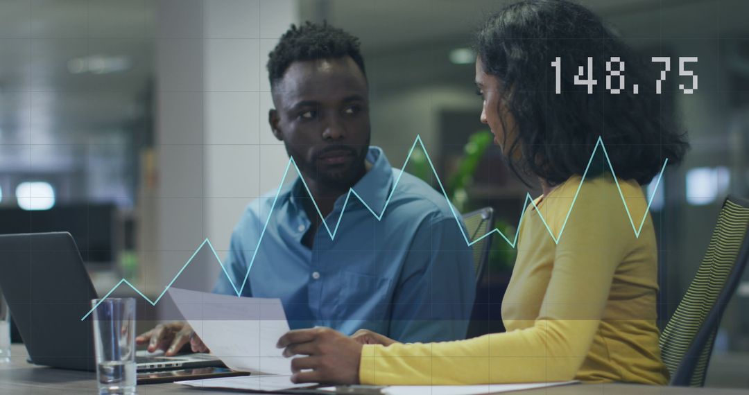 Diverse Colleagues Analyzing Market Data in Modern Office