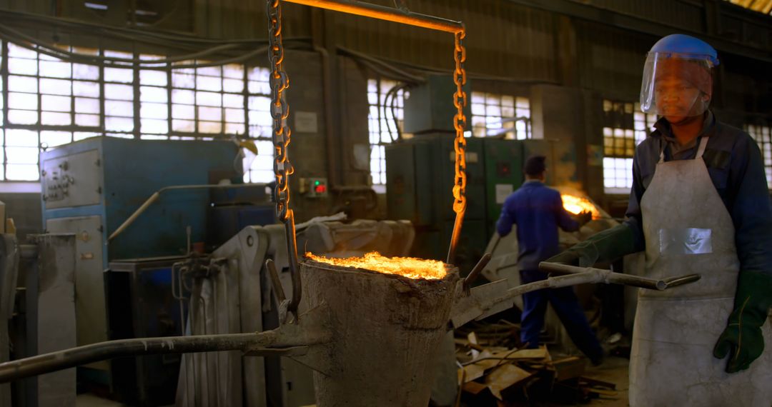 Factory Workers Pouring Molten Metal in Industrial Setting - Free Images, Stock Photos and Pictures on Pikwizard.com