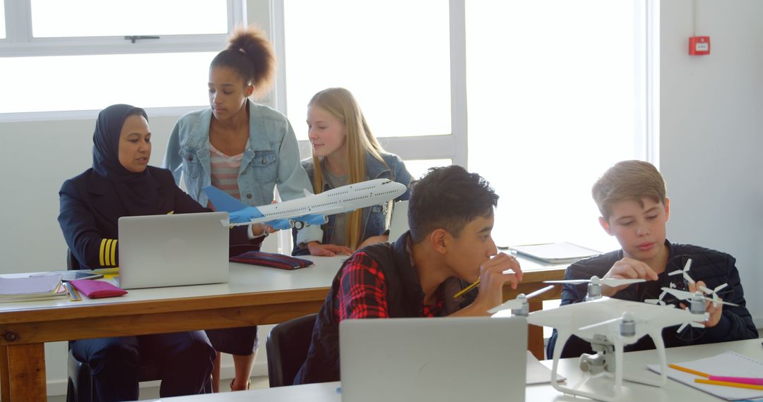 Students Collaborating on Drone Technology in Diverse Classroom - Free Images, Stock Photos and Pictures on Pikwizard.com