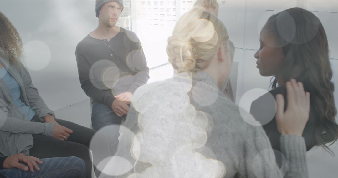 People Engaging in Group Therapy Session with Abstract Light Elements