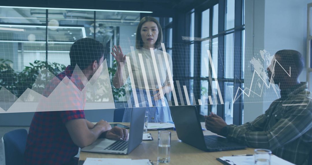 Diverse Team Brainstorming with Data Charts in Modern Office Space