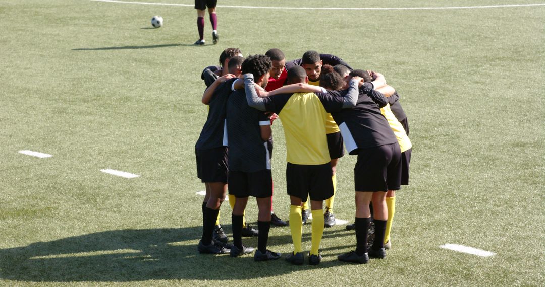 Soccer Team Huddling Showing Preparation and Unity