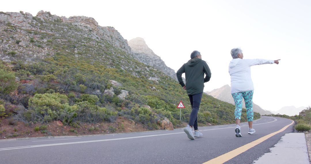 Elderly Couple Jogging Together on Mountain Road - Free Images, Stock Photos and Pictures on Pikwizard.com