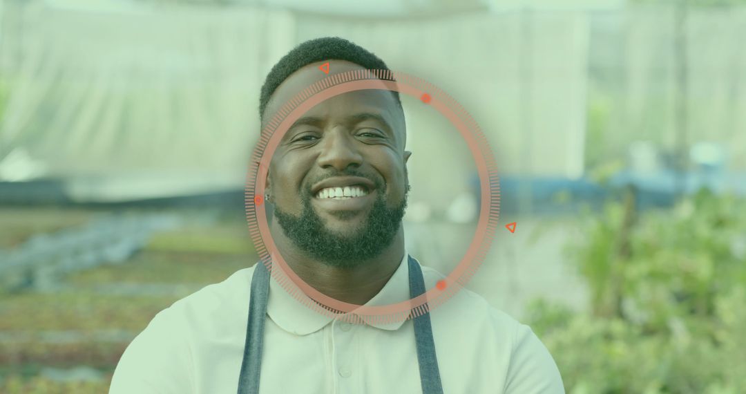 Smiling Gardener in Greenhouse with Seedlings and Apron