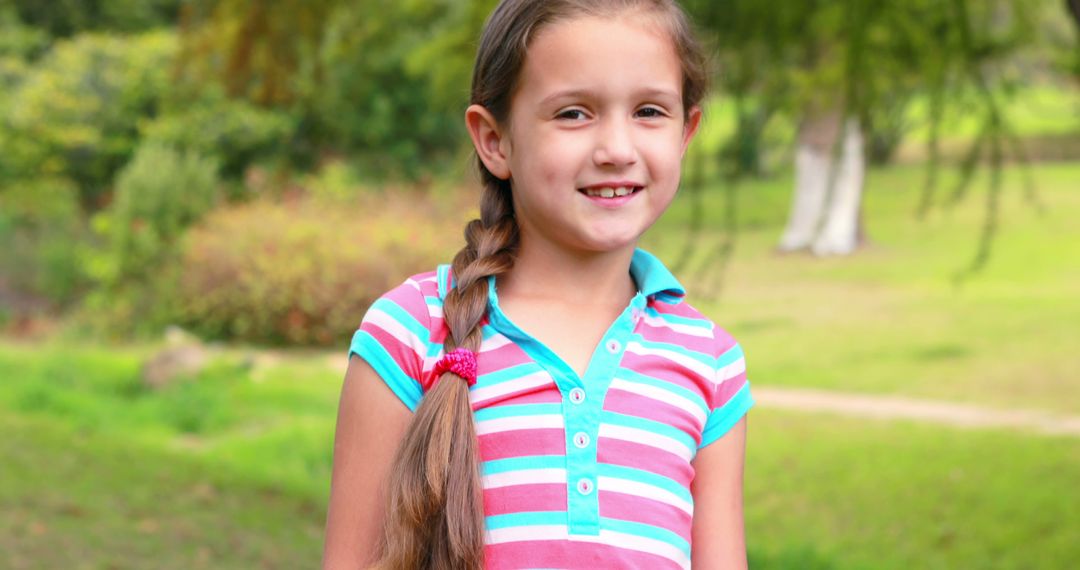 Smiling Young Girl with Braided Hair in Park Setting, Happy Outdoors - Free Images, Stock Photos and Pictures on Pikwizard.com