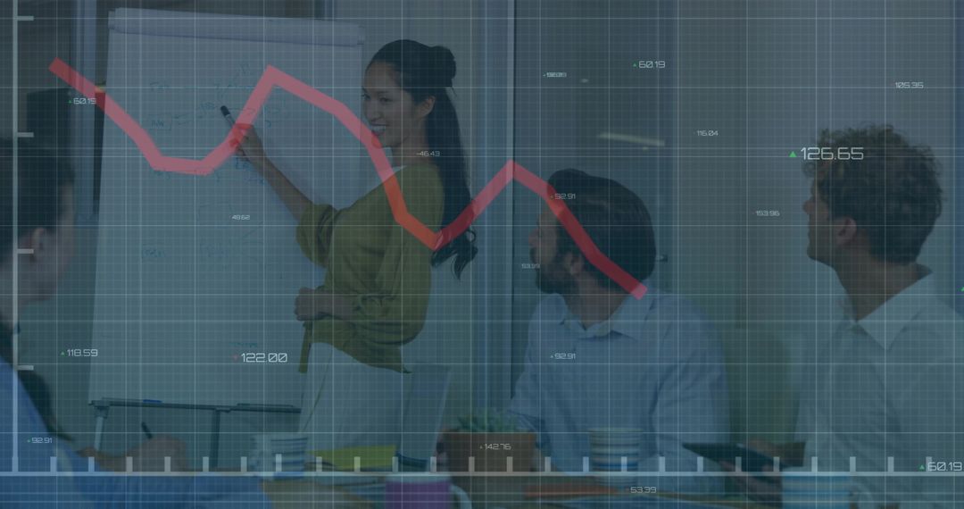 Team presenting declining stock trend on flip chart while pointing in modern meeting room