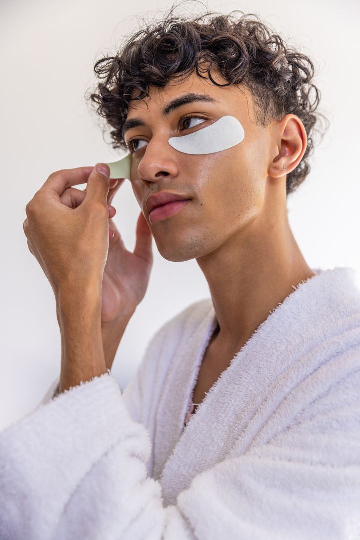 Man Applying Under-Eye Patches in Bathroom Routine