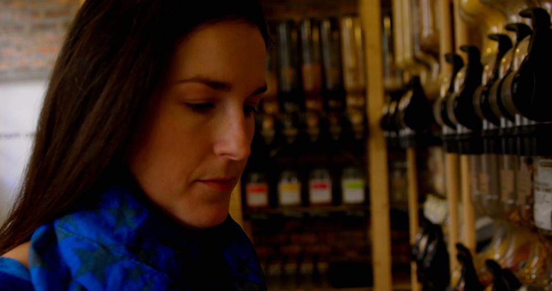 Woman Shopping in Organic Grocery Store with Spices Display - Free Images, Stock Photos and Pictures on Pikwizard.com