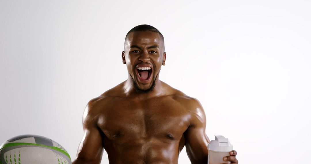 Excited Athlete Holding Rugby Ball and Protein Shake Bottle - Free Images, Stock Photos and Pictures on Pikwizard.com