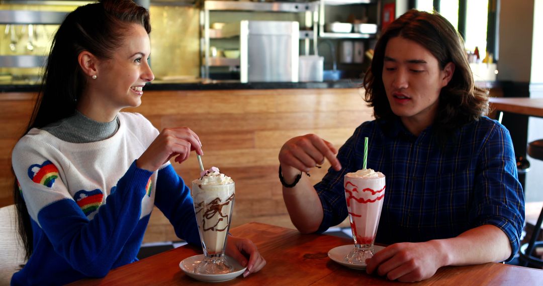 Friends Enjoying Milkshakes in Modern Cafe - Free Images, Stock Photos and Pictures on Pikwizard.com