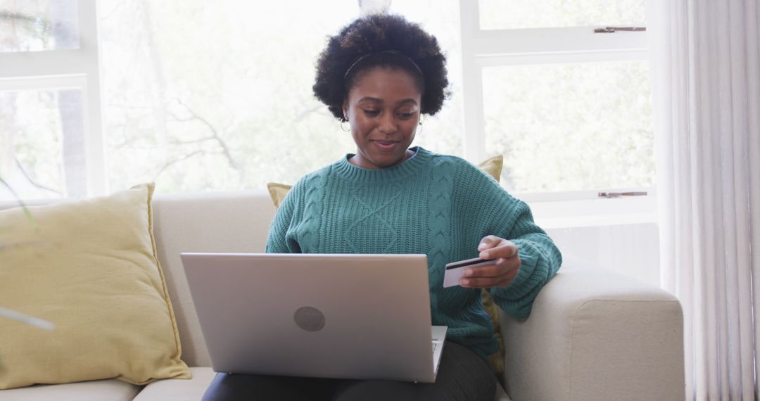 Smiling Woman Online Shopping with Laptop and Credit Card on Sofa - Free Images, Stock Photos and Pictures on Pikwizard.com