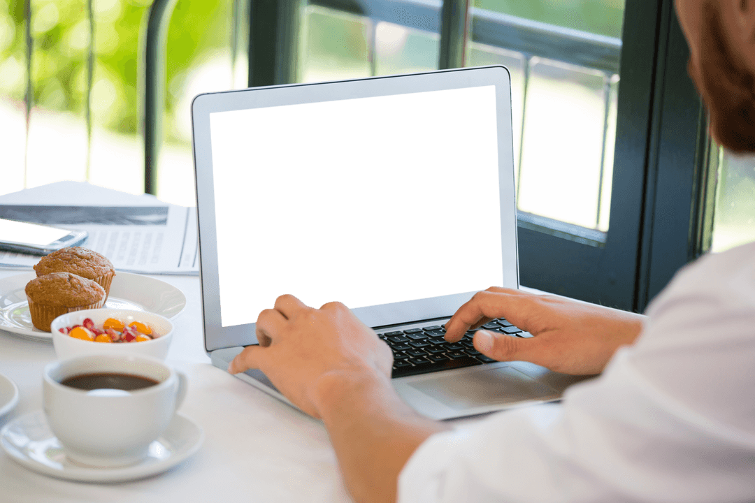Businessman in Restaurant Using Laptop with Transparent Screen