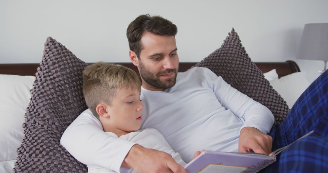 Father Reading Bedtime Story to Son in Comfortable Bedroom - Free Images, Stock Photos and Pictures on Pikwizard.com