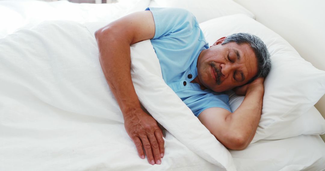 Elderly Man Sleeping Peacefully in Blue Shirt on White Bed - Free Images, Stock Photos and Pictures on Pikwizard.com