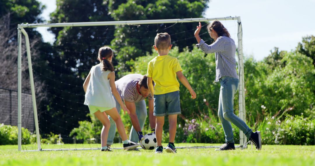 Family Enjoying Outdoor Soccer Game in Garden - Free Images, Stock Photos and Pictures on Pikwizard.com