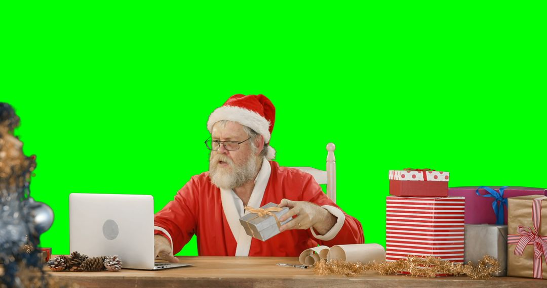 Santa Claus Working on Laptop with Presents on Desk Green Screen Background - Free Images, Stock Photos and Pictures on Pikwizard.com