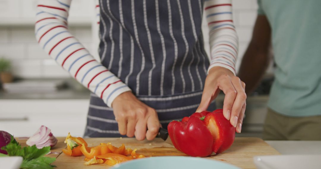 Person Chopping Red Bell Pepper for Meal Preparation - Free Images, Stock Photos and Pictures on Pikwizard.com