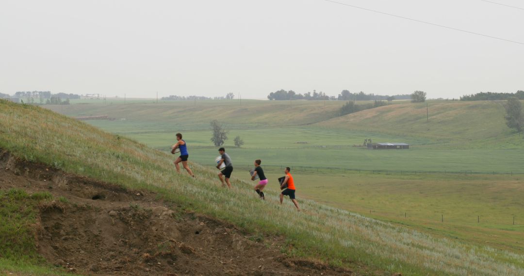 Group of Athletes Running Uphill in Rural Landscape - Free Images, Stock Photos and Pictures on Pikwizard.com