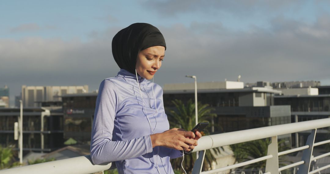 Woman in Headscarf Using Smartphone Outdoors - Free Images, Stock Photos and Pictures on Pikwizard.com