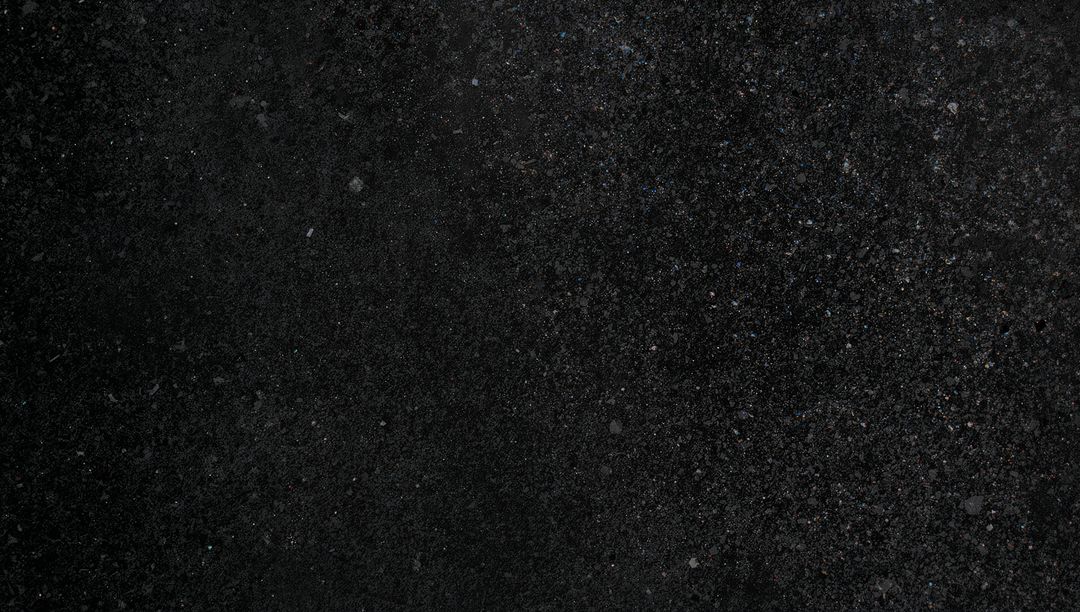 Granular Dark Asphalt Texture Close-Up Showing Speckled Pavement Surface for Backgrounds