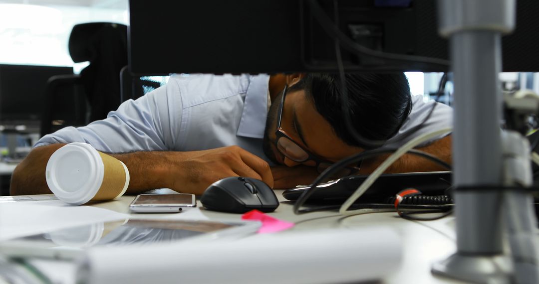 Overworked Employee Sleeping at Desk in Office - Free Images, Stock Photos and Pictures on Pikwizard.com