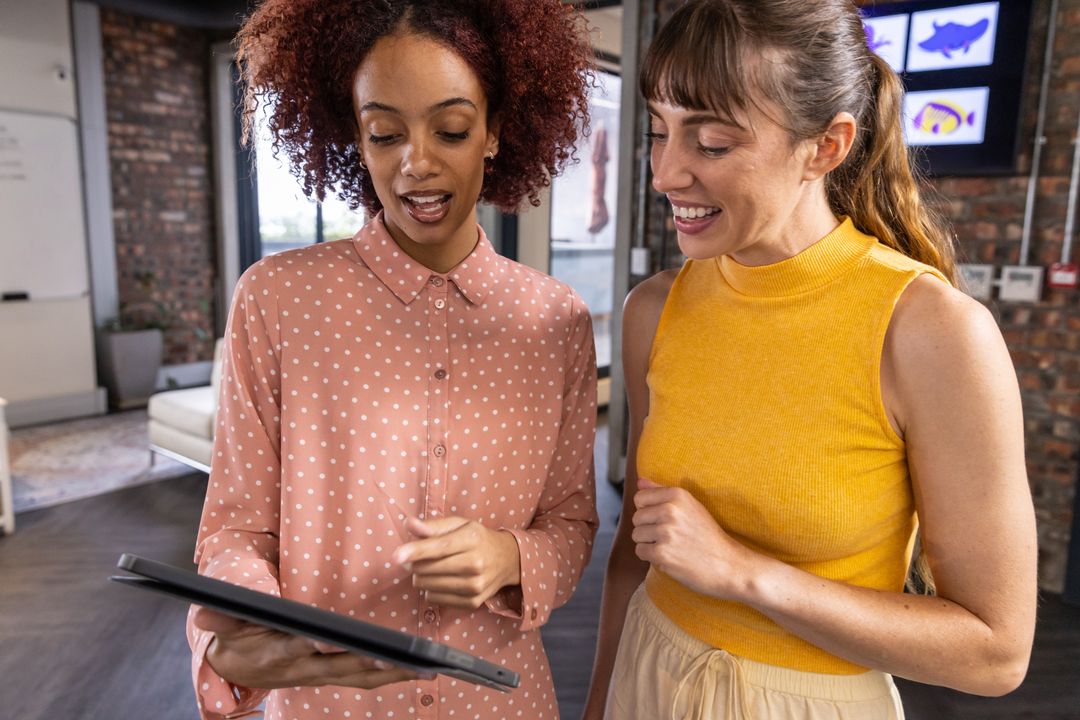 Diverse Coworkers Collaborating in Creative Office with Tablet
