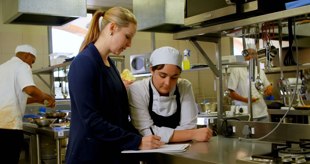 Chef receiving instructions from supervisor in a professional kitchen - Free Images, Stock Photos and Pictures on Pikwizard.com