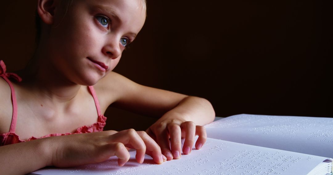 Young Girl Reading Braille Book with Focus and Curiosity - Free Images, Stock Photos and Pictures on Pikwizard.com