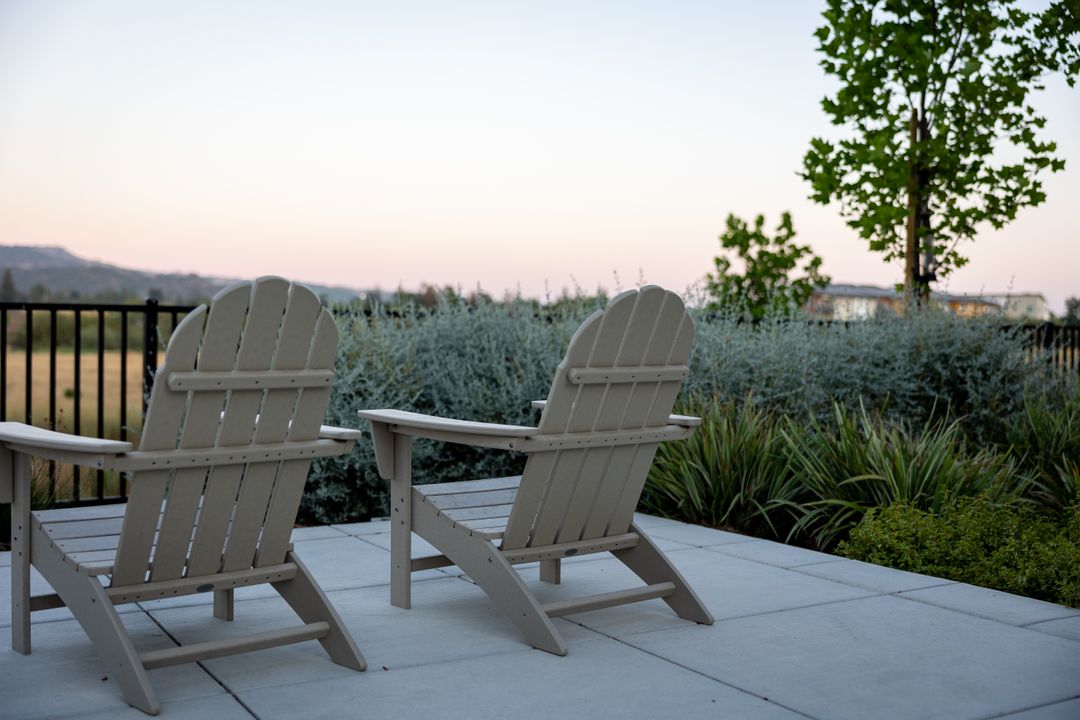 Serene Back Patio with Adirondack Chairs at Sunset