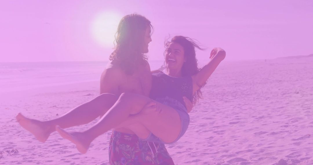Joyful Couple Enjoying Sunset Stroll on Beach