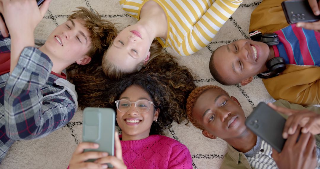 Diverse Group of Teenagers Lying on Floor Taking Selfies on Smartphones - Free Images, Stock Photos and Pictures on Pikwizard.com