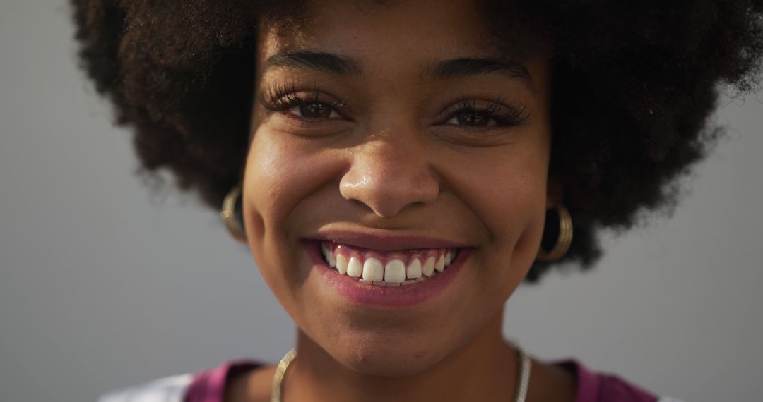 Close-Up of Smiling Woman with Curly Hair and Dimples - Free Images, Stock Photos and Pictures on Pikwizard.com