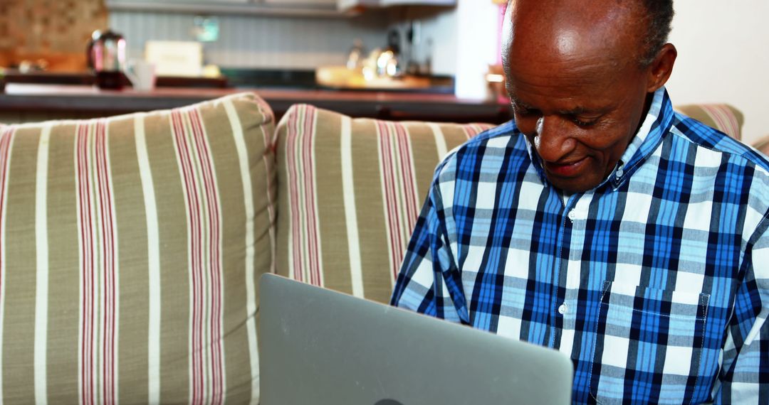 Senior African American Man Using Laptop on Couch - Free Images, Stock Photos and Pictures on Pikwizard.com