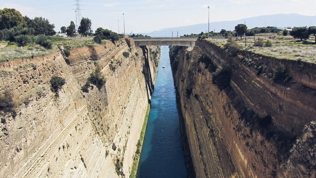 Aerial View of Historic Corinth Canal with Bridge Over Waterway - Free Images, Stock Photos and Pictures on Pikwizard.com