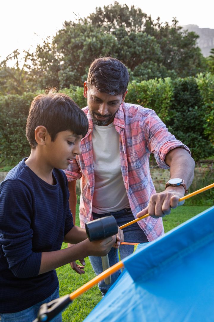 Father and Son Collaborating on Backyard Camping Tent Setup