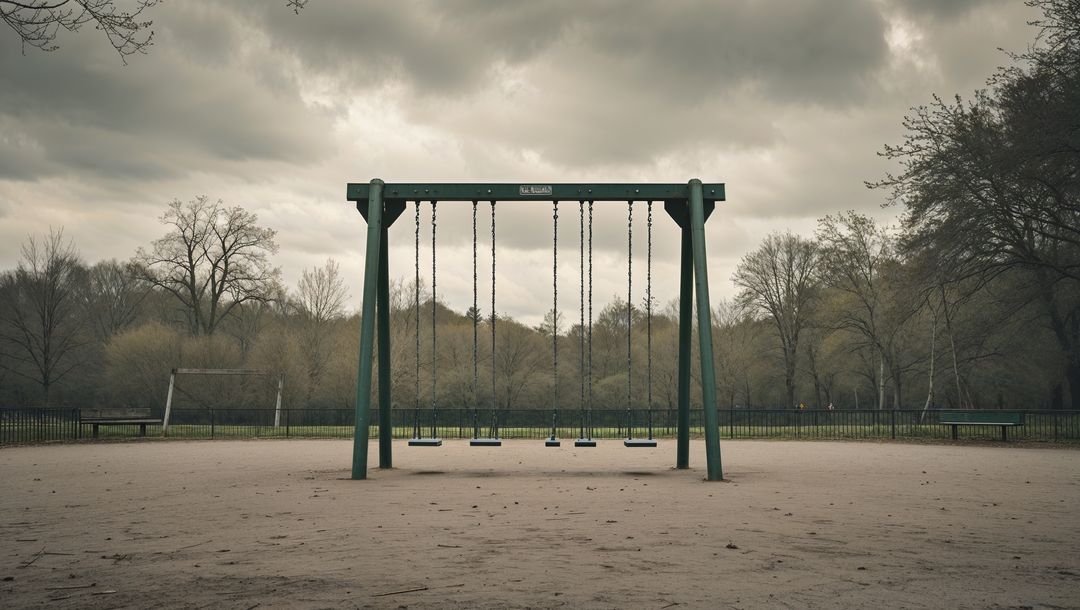 Empty Swing Set on Cloudy Day in Park Playground