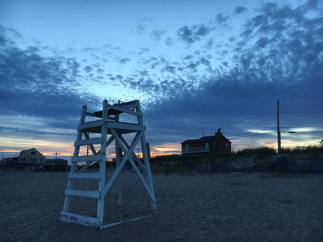 Lifeguard Chair on Quiet Beach at Dusk with Colorful Sky - Free Images, Stock Photos and Pictures on Pikwizard.com