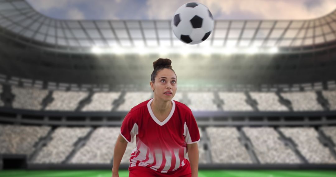 Female Soccer Player Focusing on Incoming Soccer Ball in Stadium