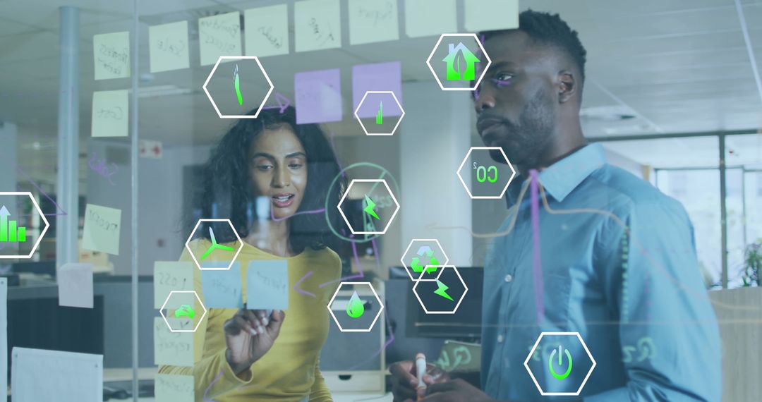 Coworkers Discussing Reports on Transparent Board with Digital Icons